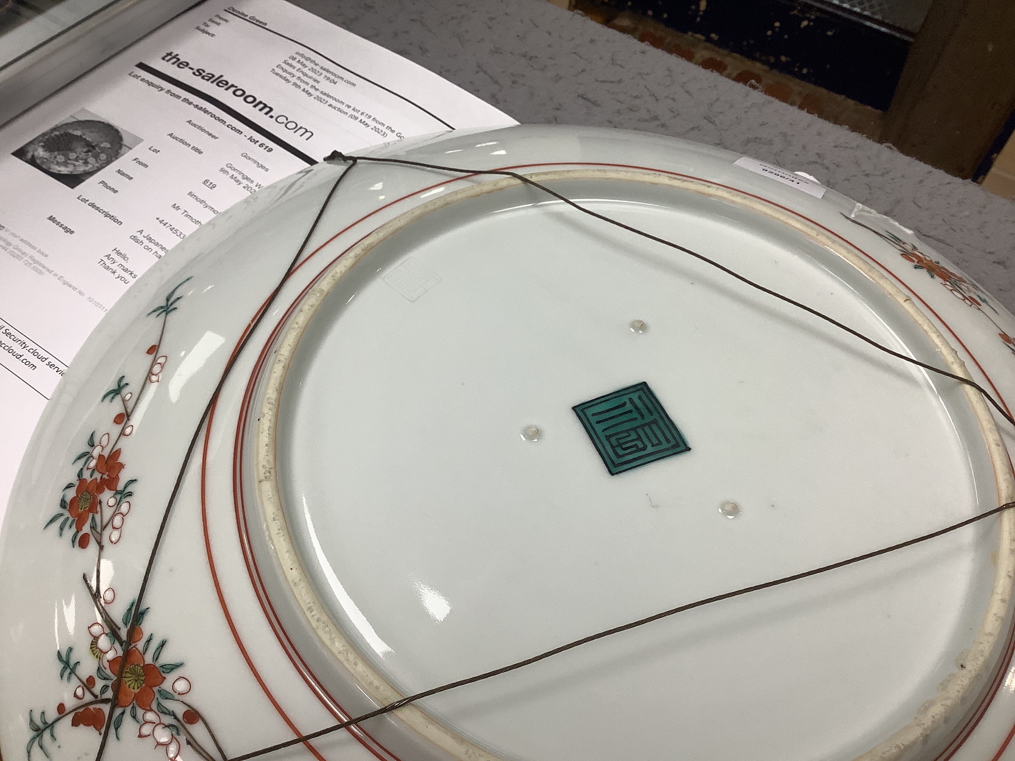 A Japanese enamelled porcelain ‘peacock’ dish on hardwood stand, dish 41cm diameter